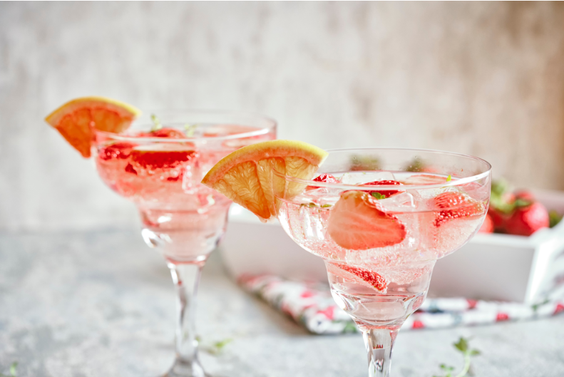 Vibrant and Refreshing Blood Orange and Strawberry Soda Delight in a Cocktail Glass - A Perfect Blend of Citrus Zest and Berry Symphony, Garnished with Slices of Blood Orange and Plump Strawberries. Cheers to Sipping Exquisite Flavours